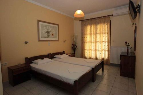 a bedroom with a large bed and a window at Almini Apartments in Plataria