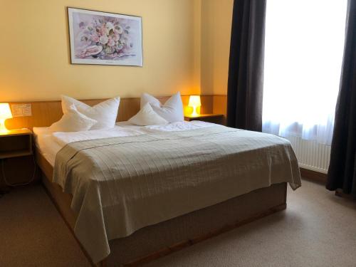 Postel nebo postele na pokoji v ubytování Hotel Hanseatic