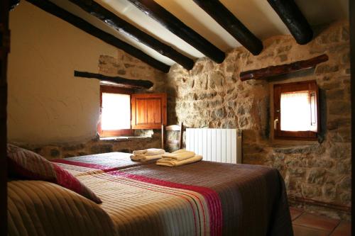 a bedroom with a bed with towels on it at Casa Leandron in Murillo de Gállego