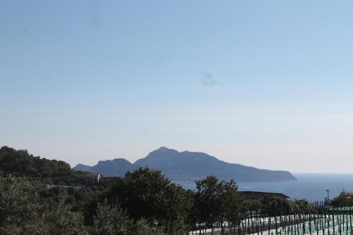 a view of the ocean with mountains in the background at Sunset House in Massa Lubrense