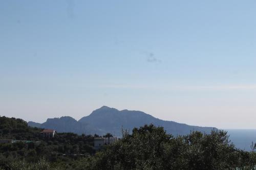 a view of the ocean and mountains in the distance at Sunset House in Massa Lubrense