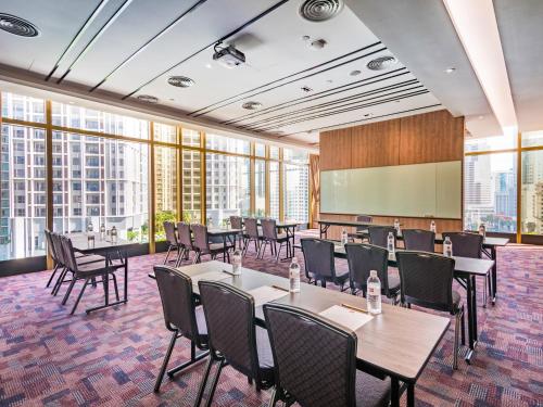 a conference room with tables and chairs and a chalkboard at ibis Kuala Lumpur City Centre in Kuala Lumpur