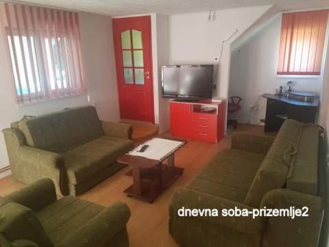 a living room with two couches and a tv at "Popov VRT" Banoštor - kuća-vikendica na Dunavu-Fruskoj Gori in Banoštor