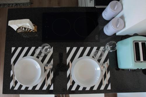 a table with two plates and cups on it at City Center Apartments in Paphos City