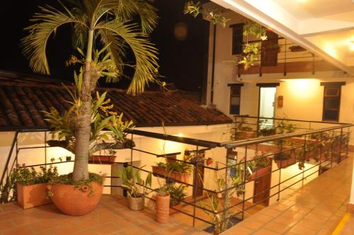 a building with a bunch of potted plants at Chrisban Hotel Boutique in Buga