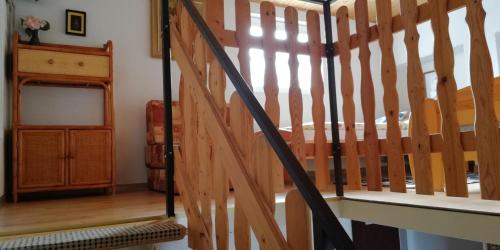 a wooden staircase in a home with a wooden railing at Zelený Dom in Bojnice