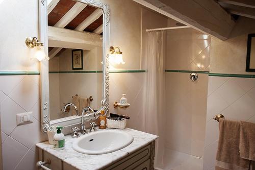 uma casa de banho com um lavatório e um espelho em Casa Carmignano em La Serra