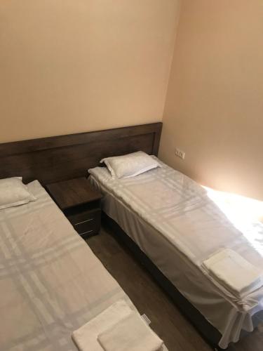 two beds in a small room withermottermott at Guest house Abovyan street in Yerevan