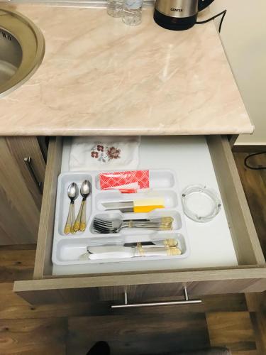 a drawer in a kitchen with utensils in it at Guest house Abovyan street in Yerevan