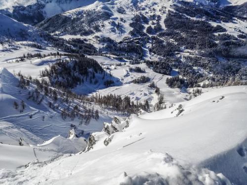 a snow covered mountain with trees in the distance at Appartements Nassfeld LUX in Sonnenalpe Nassfeld