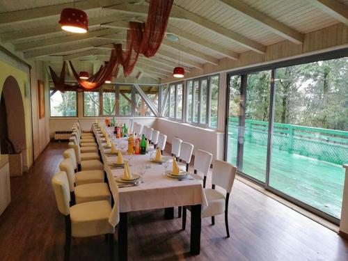 a long dining room with a long table and chairs at Hotel Park in Višići