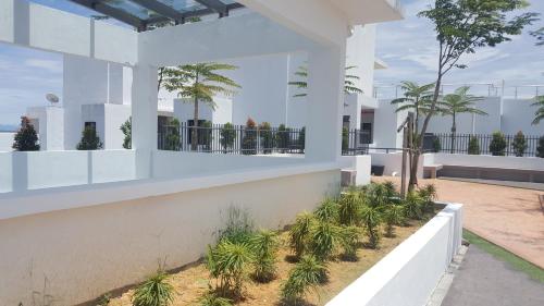 an exterior view of a house with palm trees at Prestige Sky Riverfront in Kota Bharu