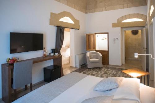 een slaapkamer met een bed en een tv aan de muur bij Palazzo Montemurro in Matera