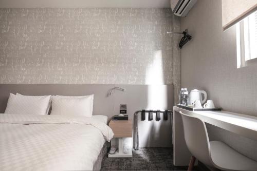 a hotel room with a bed and a sink at Cityinn Hotel Taipei Station Branch I in Taipei