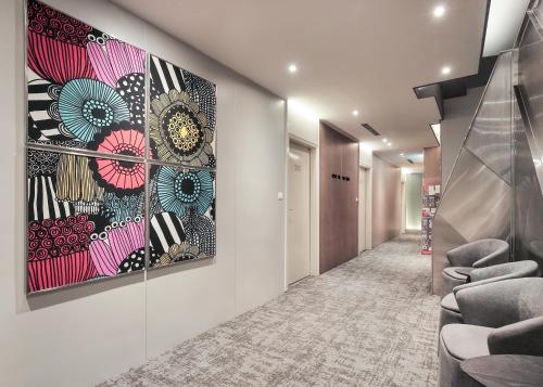 a hallway with a large painting on the wall at Cityinn Hotel Taipei Station Branch I in Taipei