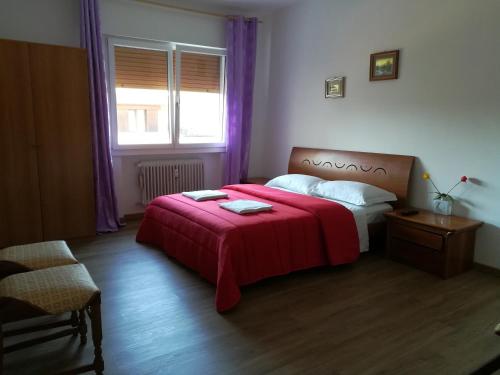 a bedroom with a bed with a red blanket at Venice Amazing House in Marghera