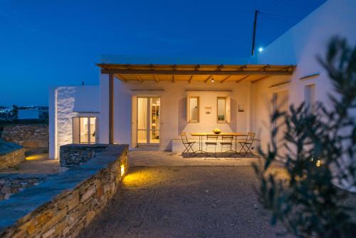 a house with a table in front of it at night at Katavati - 2 Semi-detached Houses in Apollonia