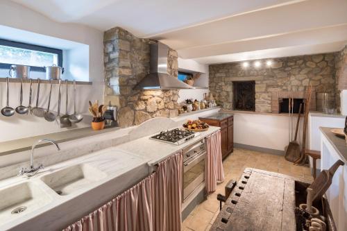 a kitchen with a sink and a stove at La Taverna Fra Le Colline in Arezzo