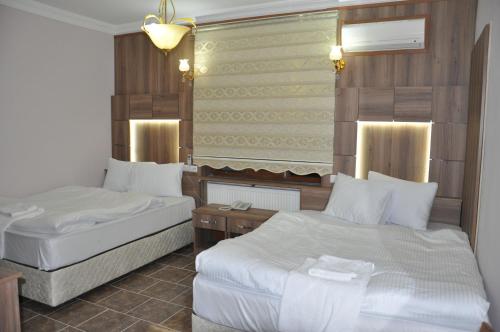 A bed or beds in a room at Mevlana Palace