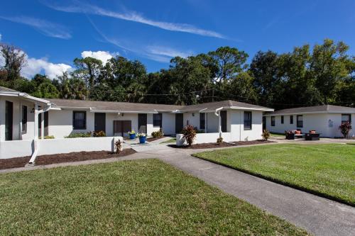 a row of houses with a driveway at Travel Inn of Titusville in Titusville
