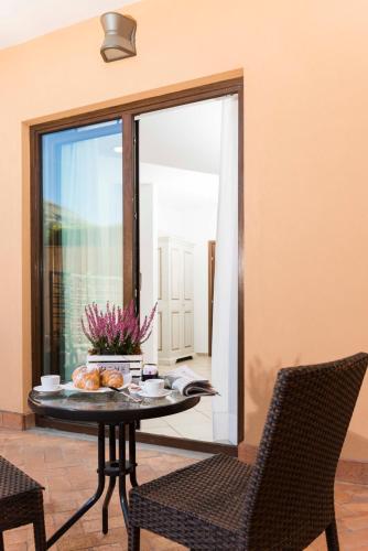a table and chairs in a room with a window at Tenuta D'Amore in San Mango Piemonte