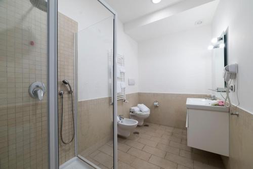 a bathroom with a shower and a toilet at Tenuta D'Amore in San Mango Piemonte