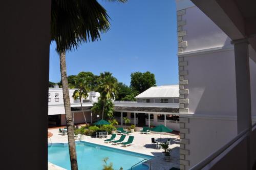 a view of the pool from the balcony of a hotel at Hotel PomMarine in Bridgetown