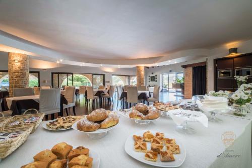 ein Tisch mit vielen Teller Essen drauf in der Unterkunft Tenuta D'Amore in San Mango Piemonte