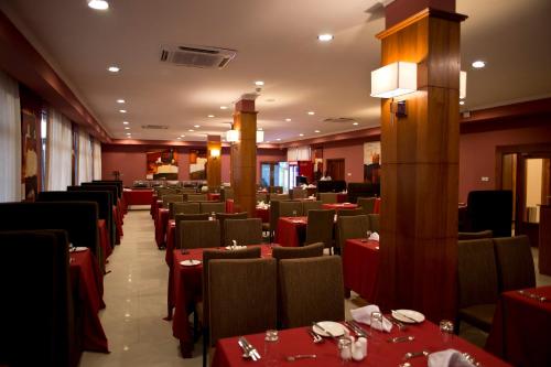 a dining room with red tables and chairs at Seascape Hotel in Dar es Salaam