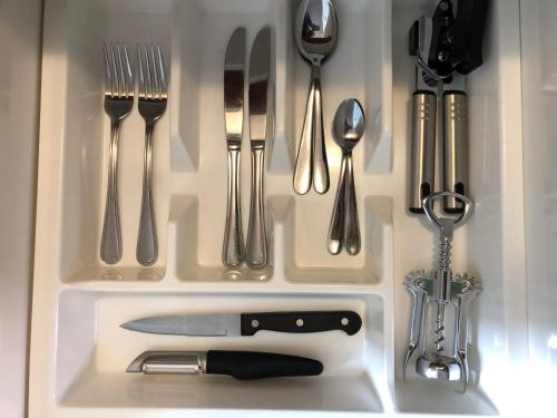 a drawer with silver utensils in a kitchen at Bella Vista Motel Te Anau in Te Anau
