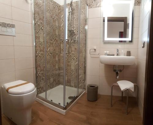 a bathroom with a shower and a toilet and a sink at B&B Il Campanile in Sciacca