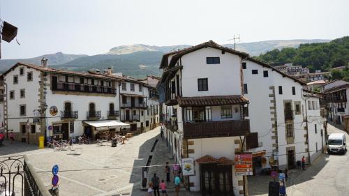 a group of buildings in a town with a street at Posada Puerta Grande in Candelario