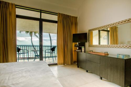 a bedroom with a bed and a view of the ocean at BV103 - Amazing Oceanfront Condo steps from beach in Humacao