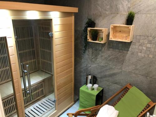 a room with a shower and a green table at Warrest - Short Rent Apartments in Milan