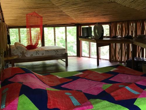 a room with a colorful rug on the floor at NuestraMadreTierra in La Esperanza