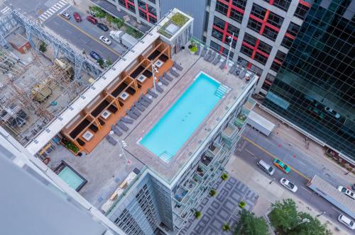 an overhead view of a city with a swimming pool at CHOL Furnished Suites Heart of Downtown Toronto, 2 Beds, Free Parking, CN Tower View in Toronto