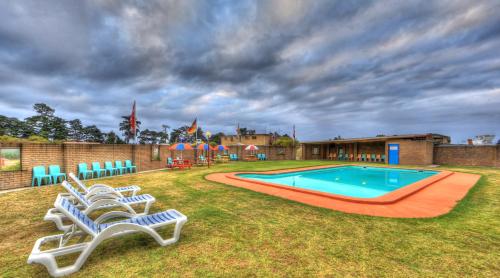 a group of chairs sitting around a swimming pool at BIG4 Kelso Sands Holiday & Native Wildlife Park in Kelso