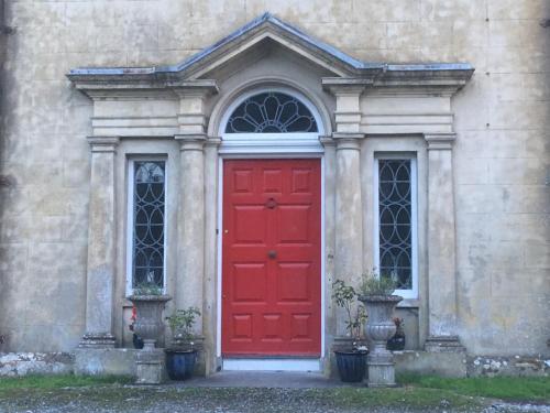 a red door on the side of a building at Castlecor House - Historic Country House in Ballymahon