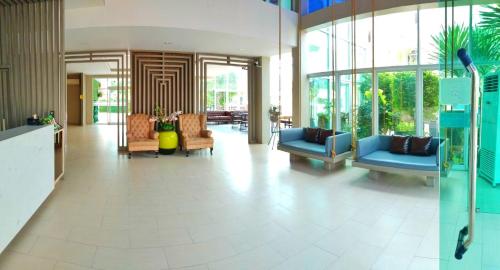 a lobby with couches and chairs in a building at Embryo Hotel  in Pattaya Central