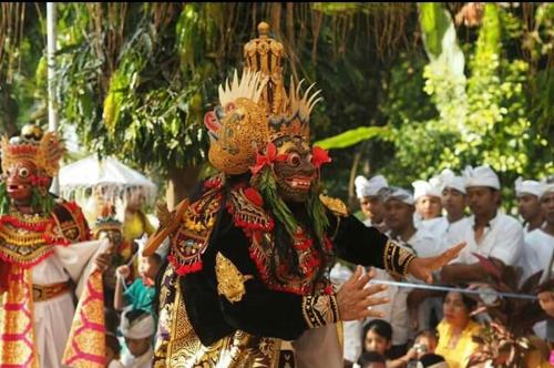 a group of people dressed in costumes in a parade at Halumba Eco Villa Bali in Tejakula