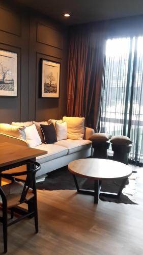 a living room with a couch and a table at Luxury King Bed Apartment with Pool View and Sauna, Spacious 57 sqm, in Rawai Beach