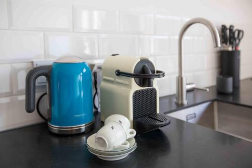 a kitchen counter with a toaster and a coffee maker at Amsterdam Area Residence Oosterwold in Almere