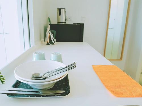 a white plate and utensils sitting on a counter at Simplicity Cozy For 2 -Trefoil Setia Alam- Near Setia City Mall-Setia Convention Centre in Shah Alam
