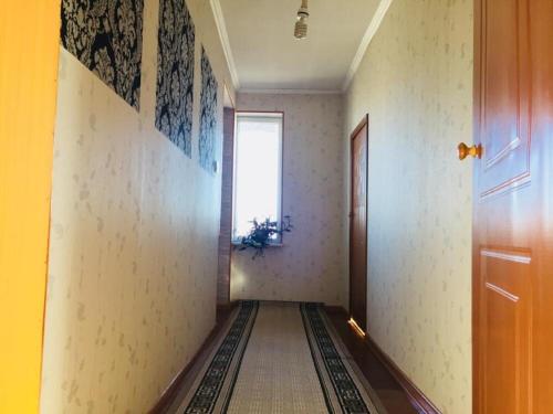 an empty hallway with a door and a window at BULBUL JAMAK TRAVEL hostel in Ölgiy