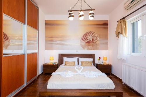 a bedroom with a bed with two towels on it at Ekaterini Vip Villa in Plaka