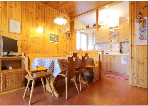 a kitchen and dining room with a table and chairs at Casa Lulu' in Predazzo