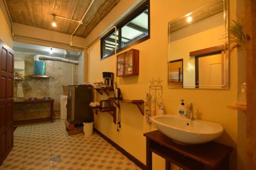 a bathroom with a sink and a mirror and a sink at The Corner's unique house in Chiang Mai