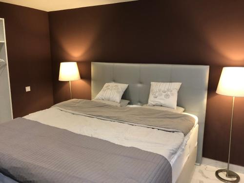 a bedroom with a large bed with two lamps at Suecia Villa Opal Anfi Tauro in Mogán