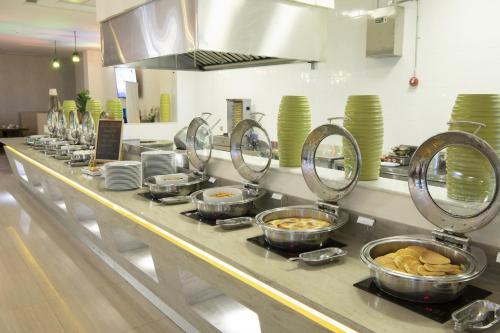 a kitchen with many bowls of food on a counter at Radisson Blu Resort Jizan in Jazan