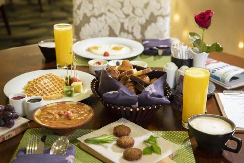 a table topped with plates of food and drinks at Radisson Blu Resort Jizan in Jazan